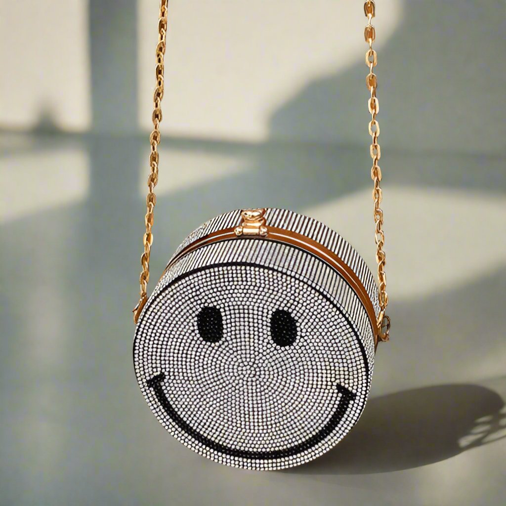 Front view of stylish Happy Lux Crossbody, smiley design, gold chain.