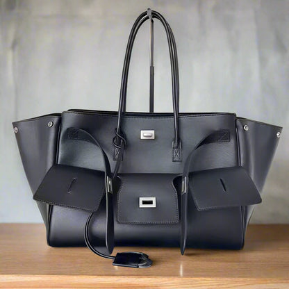 Luxurious modern black tote bag featuring silver accents, perfect for chic and stylish everyday use. Fall 2024 collection. On display.