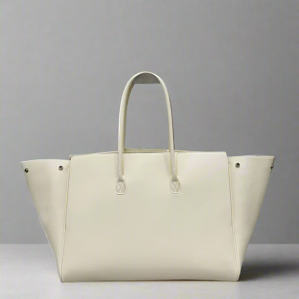 Luxurious modern ivory tote bag featuring silver accents, perfect for chic and stylish everyday use. Fall 2024 collection. Rear View.