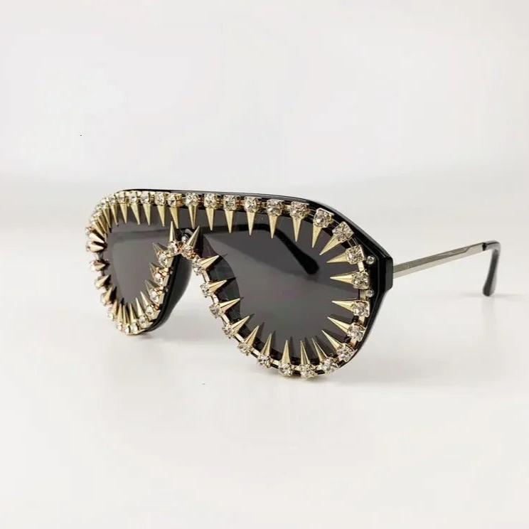 Side view of Spiked Crystal Shield sunglasses, dark lenses, spiked crystals, bold style.